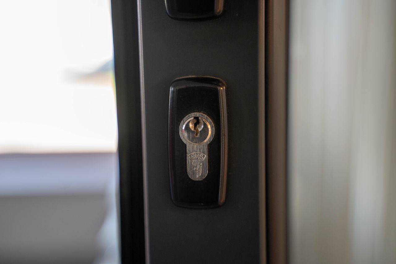 services-01 Detailed view of a steel keyhole on a door ensuring security and privacy.