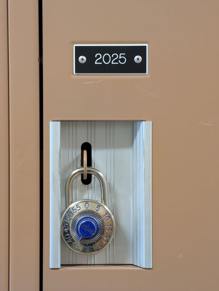 Close-up of a combination lock securing a beige locker labeled 2025.