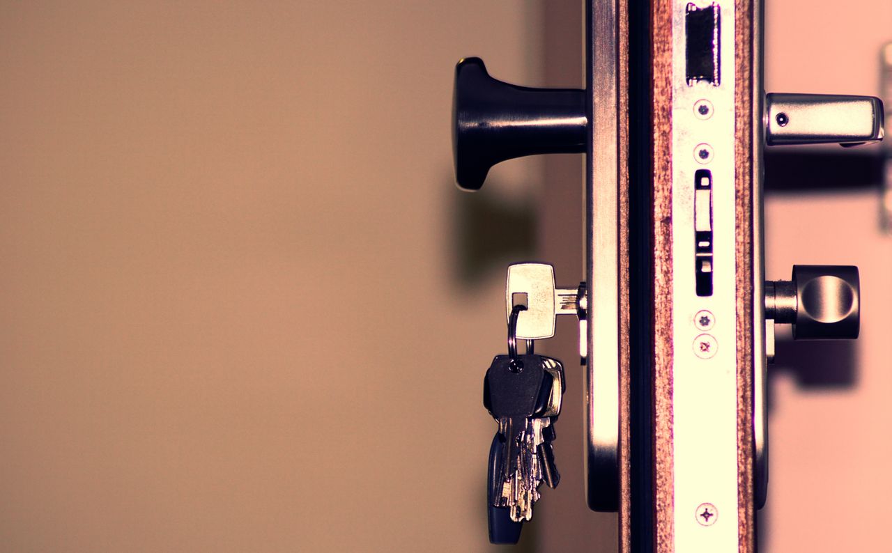 services-01 Detailed view of a door lock and keys emphasizing security and access.